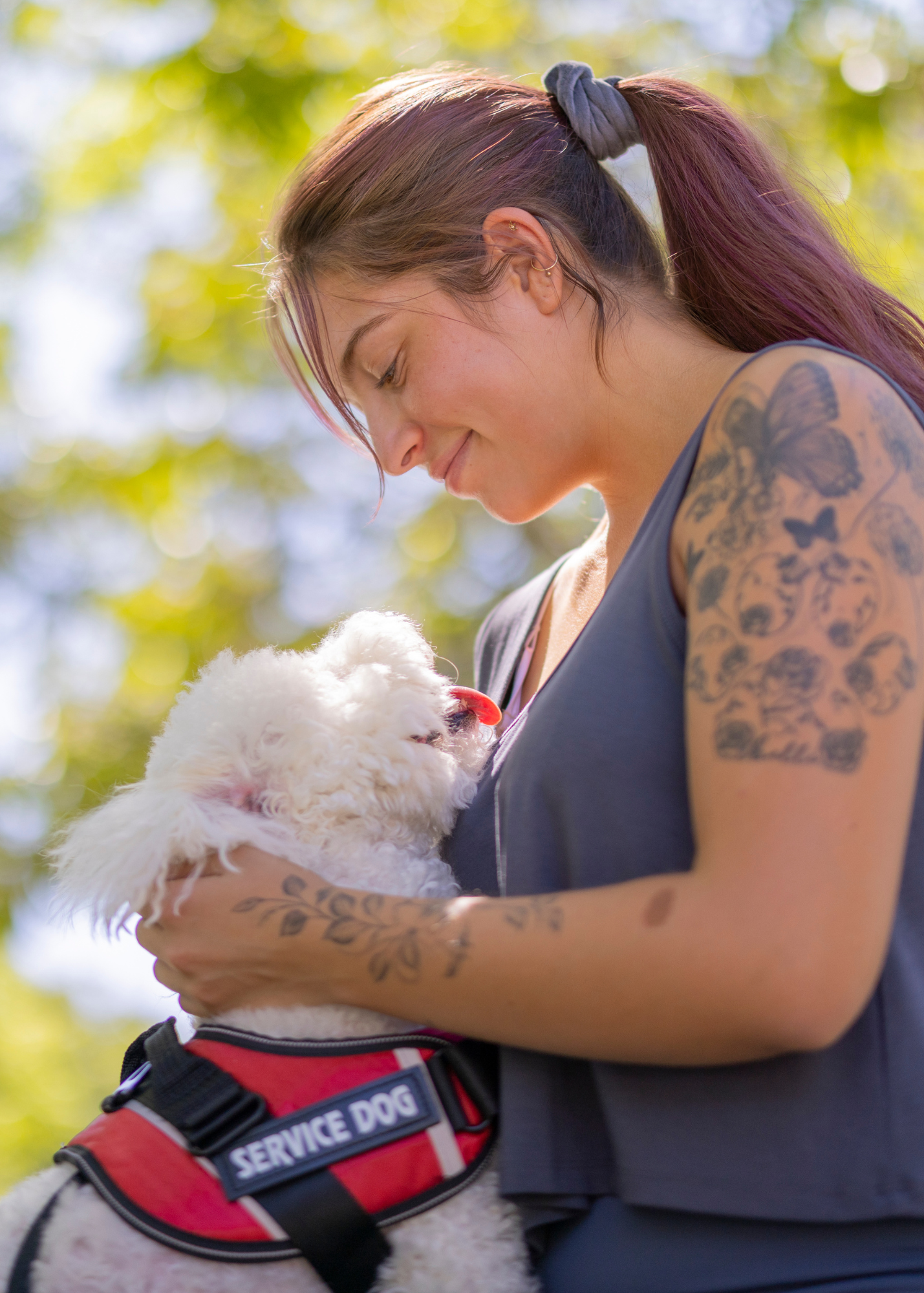 Photo of a woman hugging her service dog